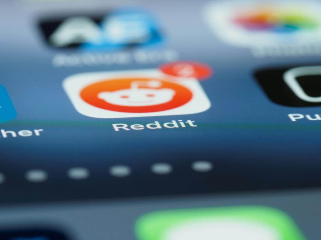 pexels-photo-7568293-7568293 Detailed close-up of a smartphone screen showing the Reddit app with a notification badge.